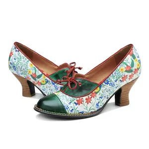 Vintage floral print high heels with green leather patchwork and red lace-up detail.