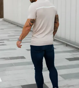 Back view of slim fit beige knitted short sleeve shirt with white contrast stripe.