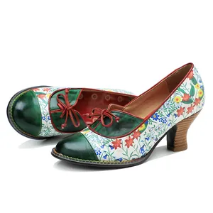 Detailed view of retro floral patchwork high heel pumps with green leather accents