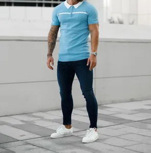 Men's slim-fit light blue polo shirt with white collar detail worn by a model outdoors