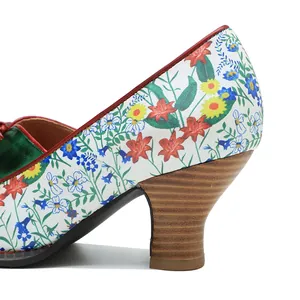Detailed close-up of vintage floral pattern and wood texture block heel on elegant pumps