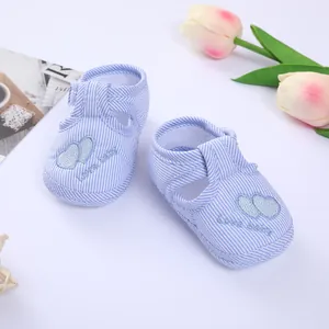 Close-up detail of blue striped soft sole baby shoes with double heart embroidery
