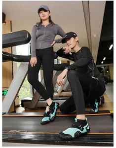 Close-up view of high-top wading shoes being worn by models in a modern fitness gym