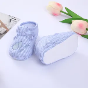 Close-up of blue striped baby walking shoes with soft non-slip sole and heart detail