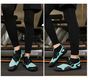 Detail of mint green high-top wading shoes on a treadmill in a fitness gym setting