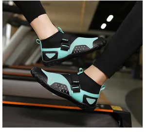 Breathable high-top aqua shoes in mint green and black shown worn on a gym treadmill