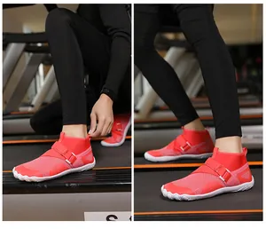 Detailed view of vibrant red breathable high-top water shoes being worn on a treadmill