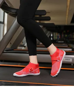 Macro view of red high-top breathable wading shoes with Velcro strap on treadmill