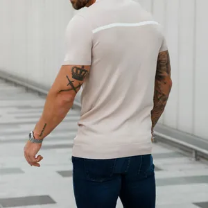 Back view detail of men's slim fit beige knit short sleeve shirt with white contrast stripe.