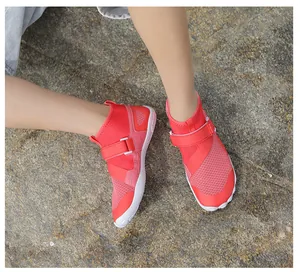 Red high-top breathable quick-dry water shoes worn on rocky outdoor wading terrain