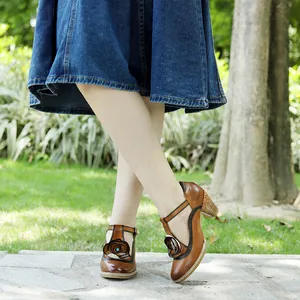 Close-up of vintage handmade leather Mary Jane high heels featuring a unique flower ornament