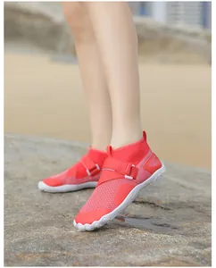 A detail shot of red high-top water shoes featuring breathable mesh and anti-slip soles