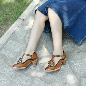 Detail view of vintage hand-rubbed leather Mary Jane heels with T-strap on stone pavement