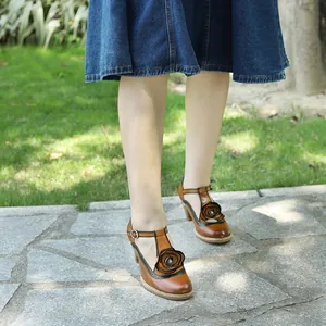 Close-up detail of retro hand-rubbed leather Mary Jane heels featuring large rose decoration