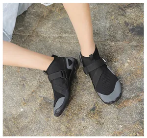 High-top breathable water shoes with anti-slip sole worn on rocky outdoor terrain.