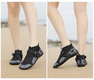 Detailed view showing the breathable mesh and anti-slip sole of black high-top water shoes on sand