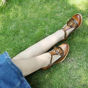 Elegant handmade vintage brown leather Mary Jane heels with 3D flower detail on green grass