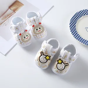 Detail view of cute cartoon baby cloth shoes with soft soles and velcro strap