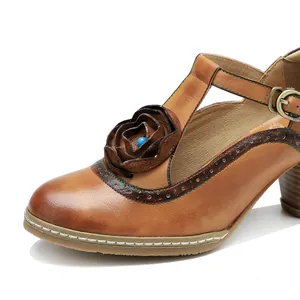 Macro view of handmade leather floral detail on vintage burnished Mary Jane heels