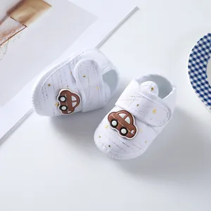 Soft sole baby shoes featuring cute car decoration and golden star patterns macro view