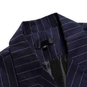 Close-up of peak lapel and pinstripe texture on a navy blue double-breasted suit jacket