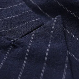 Close-up view of navy blue pinstripe fabric for men's professional blazer jacket
