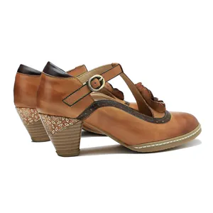 Detailed view of vintage hand-rubbed leather Mary Jane heels with floral accents.