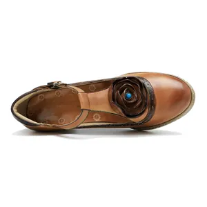 Detailed top view of a handmade vintage leather Mary Jane shoe featuring a large rose