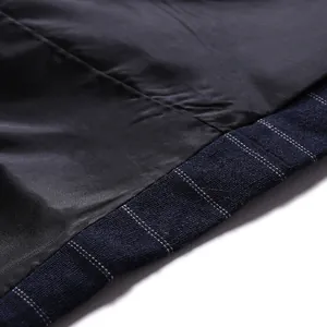 Detail of smooth inner lining and navy pinstripe outer fabric of a men's business suit.