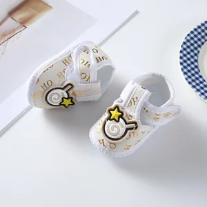 Detail view of soft-sole baby cloth shoes with cute lollipop and star patches