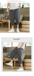 Detail view of men's dark grey linen harem pants featuring a minimalist Zen-style design