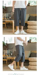 Close-up of men's gray linen harem cropped pants showing side and front details