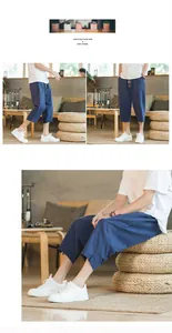 Detail view of men's blue linen harem pants in a cozy indoor lifestyle setting
