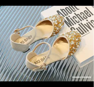 Detail shot of sparkling gold girls princess shoes with pearls and rhinestones.