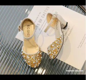 Detail of girls princess shoes featuring pearls and golden sequins decor