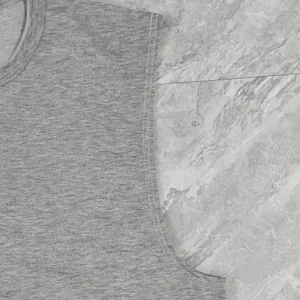 Detail view of grey cotton tank top showing reinforced shoulder seams and stitching texture