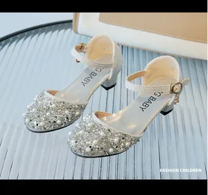 Detail of girls' silver crystal shoes featuring elegant pearls and sparkling rhinestones