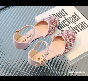 Elegant detail of pink girls' princess dress shoes adorned with sparkling rhinestones and pearls