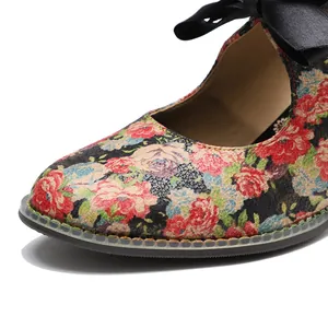 Detailed view of vintage floral print and black bow on pastoral style high heels