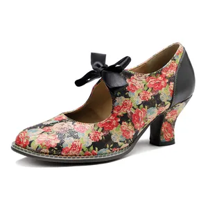 Macro view of vintage floral print pumps with a delicate black satin bow detail