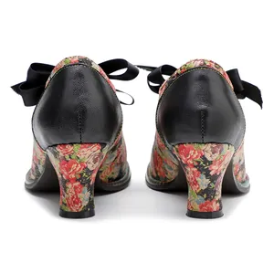 Detailed rear view of retro floral high heels with black leather back and silk bow