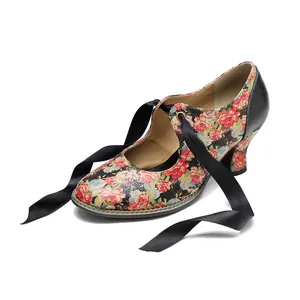 Side detail view of vintage floral high heels featuring black satin ribbon lace-up ties