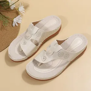 Comfortable white thong wedge flip-flops with decorative buttons and cut-out details