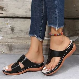 Side view of comfortable women's wedge thong sandals with thick platform soles.