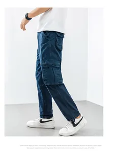Side view of dark blue loose cargo pants featuring large side flap pockets for men.