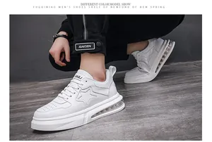 Detailed view of white men's platform sneakers with star pattern and air cushion sole.