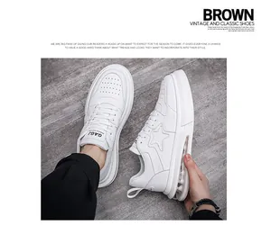 Detailed view of white men's fashion sneakers featuring an air cushion sole and star embroidery