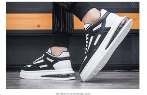 Close-up detail of stylish black and white men's air cushion sneakers on a male model