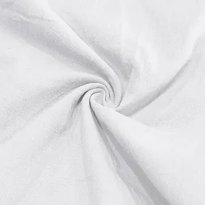 Close-up detail showing the breathable texture of white linen fabric for men's shorts.