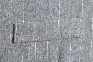 Close-up detail of grey pinstripe fabric and welt pocket on men's vintage vest